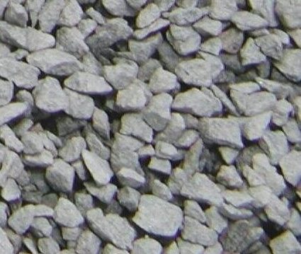 Close-up image of a pile of small, irregular gray stones, suitable for use in construction, landscaping, or as gravel for pathways.